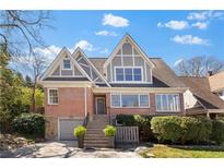 Charming two-story brick home featuring eye-catching gables and a well-manicured front yard at 1824 Windemere Ne Dr, Atlanta, GA 30324