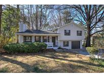Charming two-story home with covered porch and a well-manicured front yard at 3184 Pinto Dr, Powder Springs, GA 30127