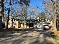 Charming single-story home featuring a driveway and attached garage at 3511 Flint Ave, Ellenwood, GA 30294