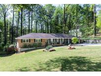 Beautiful brick home featuring a well-manicured lawn and lush landscaping at 4323 E Durham Cir, Stone Mountain, GA 30083