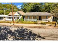 Charming home featuring a covered front porch and fenced yard, perfect for relaxation and outdoor activities at 1644 Lakewood Se Ave, Atlanta, GA 30315