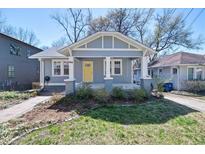 Charming craftsman-style home featuring a welcoming front porch and a bright yellow door at 1095 Boulevard Se Dr, Atlanta, GA 30317