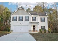 Charming two-story home with a two-car garage and beautifully manicured front yard at 382 Daffodil Dr, Temple, GA 30179