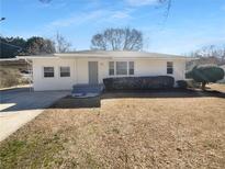 Charming single-story home with a well-maintained lawn and covered parking, perfect for comfortable living at 233 Bay Creek Rd, Loganville, GA 30052