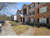 Attractive apartment building with stone accents, manicured landscaping, and convenient parking at 5303 Fairington Club Dr # 5303, Lithonia, GA 30038