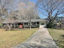 Charming single story home with a red front door and an attached garage at 2179 Powers Ferry Dr, Marietta, GA 30067