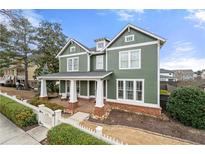 Charming two-story home with a welcoming front porch and manicured landscaping at 174 Kelly St, Norcross, GA 30071