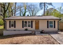 Charming single-story home featuring a well-maintained yard and classic architectural details at 3351 Phillip Cir, Decatur, GA 30032