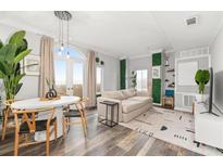 Bright living room featuring a dining table, modern furniture, and light hardwood floors at 2161 Peachtree Ne Rd # 508, Atlanta, GA 30309