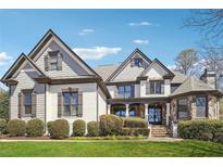 Charming two-story home featuring a brick facade, manicured lawn, and architectural roof lines at 789 Pathview Ct, Dacula, GA 30019