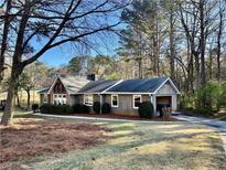 Cozy home with a rustic exterior and a well-manicured lawn showcasing classic charm at 3252 Westbrook Trce, Lawrenceville, GA 30044