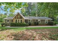 Charming single-story home with stone accents, mature trees, and well-maintained landscaping at 3252 Westbrook Trce, Lawrenceville, GA 30044