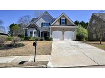 Charming two-story home featuring stone accents, a manicured lawn, and an attached two-car garage at 109 Oak Haven Dr, Canton, GA 30115