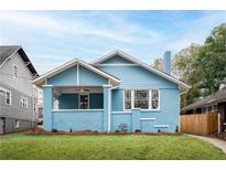 Charming blue bungalow with a well-manicured lawn and inviting front porch at 1453 Hartford Sw Ave, Atlanta, GA 30310