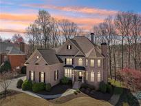 Stunning brick home featuring manicured landscaping and a welcoming front entrance at 4075 Homestead Ridge Dr, Cumming, GA 30041