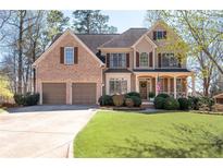 Beautiful two-story home with a brick facade, a well-manicured lawn, and a two-car garage at 5383 Fawn Meadow Ln, Powder Springs, GA 30127