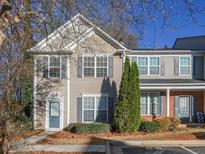 Charming two-story townhome with light siding, gray shutters, and a well-maintained front yard at 4645 Valais Ct # 89, Alpharetta, GA 30022