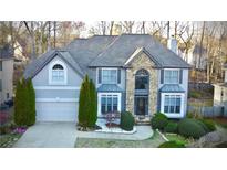Charming two-story home with stone accents, manicured landscaping, and attached two-car garage at 1185 Whitehawk Trl, Lawrenceville, GA 30043
