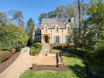 Charming two-story home with blue shutters, stone stairs, manicured lawn, and a welcoming front entrance at 160 Peachtree Ne Way, Atlanta, GA 30305