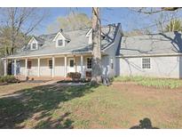 Charming single-story home featuring a covered porch, dormer windows, and a well-maintained front lawn at 75 Price Dr, Locust Grove, GA 30248