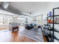 Bright living room boasts hardwood floors, modern decor, and an open layout with ample natural light at 1029 Piedmont Ne Ave # 305, Atlanta, GA 30309