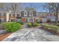 Charming brick townhouse with a well-maintained front yard and inviting curb appeal at 1923 Ivy Glen Se Dr, Smyrna, GA 30082