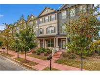 Charming townhome exterior with brick walkway, lush landscaping, and neutral color scheme at 3651 Princeton Ave, Atlanta, GA 30337