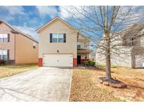 Charming home featuring a two-car garage and well-maintained lawn, perfect for suburban living at 1332 Worcester Trl, Mcdonough, GA 30253