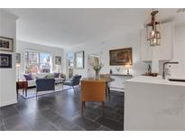 Bright living room featuring an open floorplan with modern decor, large windows, and stylish furnishings at 1101 Juniper Ne St # 519, Atlanta, GA 30309