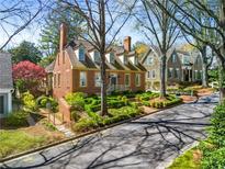 Charming two-story brick home featuring manicured landscaping and a classic colonial design at 3582 Grove Gate Ln, Atlanta, GA 30339