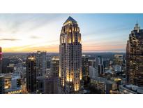 Stunning twilight view of the city featuring a tall skyscraper beautifully lit and standing out against the colorful sky at 75 14Th Ne St # 3430, Atlanta, GA 30309