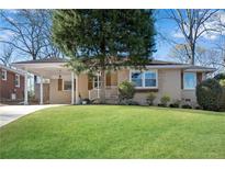 Charming single-story home boasting a well-manicured lawn and a cozy covered carport area at 1499 May Se Ave, Atlanta, GA 30316