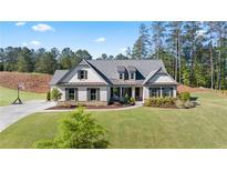 Charming one-story home with white brick, dark shutters, and a well-manicured lawn at 1160 Carl Sanders Dr, Acworth, GA 30101