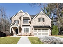 Charming two-story brick home with a well-manicured lawn and a two-car garage at 1300 Winfair Ne Ln, Brookhaven, GA 30329