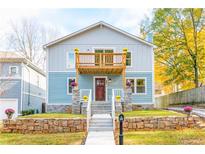 Charming two-story home with a light blue facade, complemented by a wooden balcony and stone accents at 263 Ohm Ave, Avondale Estates, GA 30002