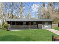 Charming ranch-style home with a welcoming front porch and a lush green lawn at 282 Oak Se Dr, Atlanta, GA 30354