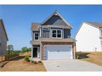 Charming two-story home with a stone-accented facade, two-car garage, and manicured lawn, perfect for curb appeal at 266 Eva Ne Way, Cartersville, GA 30121