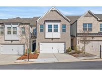 Charming brick townhome with a two-car garage and inviting curb appeal at 2855 Mcmurtry St, Cumming, GA 30041