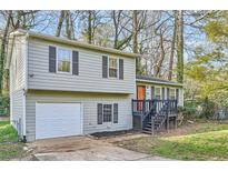 Charming split-level home with gray siding, black shutters, and an attached single-car garage at 840 Wells Se Cir, Smyrna, GA 30080