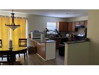 Eat-in kitchen with granite countertops, dark cabinets, and stainless steel appliances at 72 Belmonte Sw Cir, Atlanta, GA 30311
