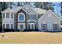 Elegant two-story home with a stone accent, beautiful windows, gray shutters, and a well-manicured lawn at 3579 Eagle Rise, Lithonia, GA 30038