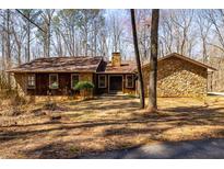 Charming stone and wood home featuring a stone chimney and double door entrance at 166 Muse Rd, Fayetteville, GA 30214