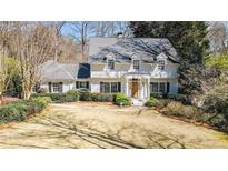 Charming two-story home featuring a manicured front yard,dormer windows, and a welcoming front entrance at 3391 Pinestream Nw Rd, Atlanta, GA 30327