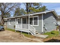 Charming single-story home with gray siding, a cozy porch, and well-maintained landscaping at 866 United Se Ave, Atlanta, GA 30312