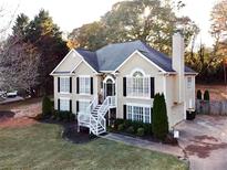 Charming two-story home with a landscaped front yard and welcoming white staircase at 2515 Little John Ct, Cumming, GA 30040