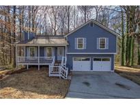 Charming two-story home with a well-maintained front yard and two-car garage at 63 Colette Ct, Douglasville, GA 30134