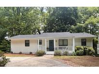 Charming single-story home featuring a welcoming front porch and well-maintained landscaping at 3841 Admiral Dr, Atlanta, GA 30341