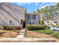 Charming townhome featuring a well-maintained lawn and inviting front entrance at 566 Trillum Sw Ct, Marietta, GA 30008