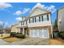 Charming two-story home featuring a stone accented garage and inviting blue shutters and trim against a blue sky at , Atlanta, GA 30318