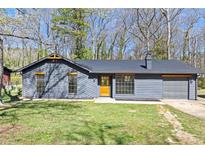 Charming single-story home with a gray exterior, well-manicured lawn, and a cozy, inviting facade at 8212 Englewood Trl, Riverdale, GA 30274